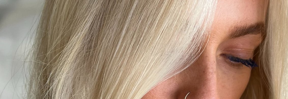 a woman with blonde hair and piercings on her face