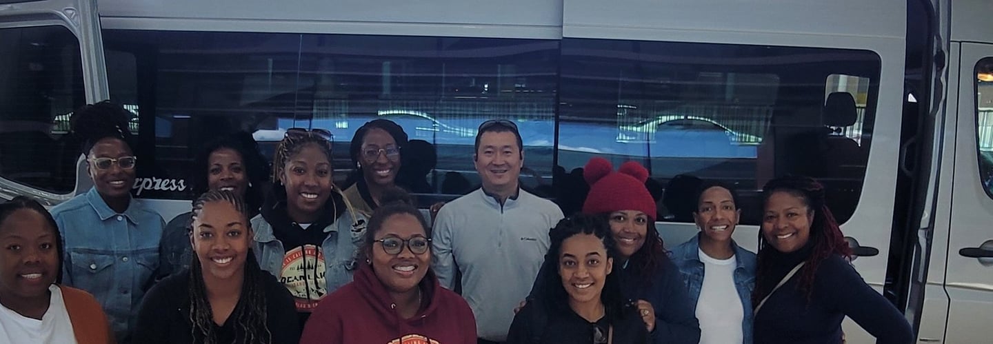 Satisfied customers in front of our high-roof Sprinter van after a tour