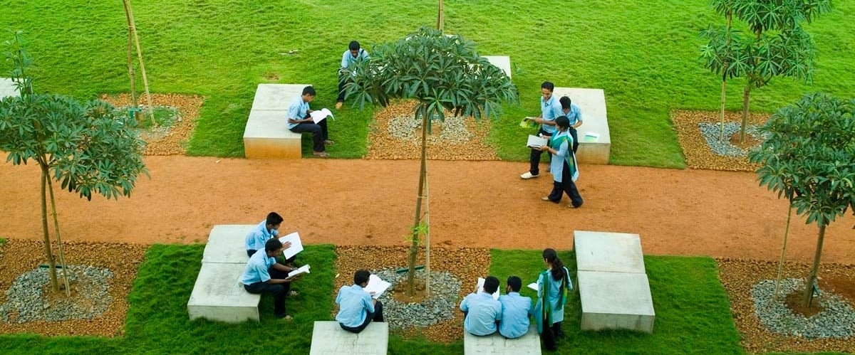 BIT Polytechnic students sitting on concrete benches
