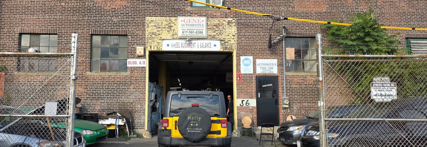a car parked in front of a building with a fire hydrant