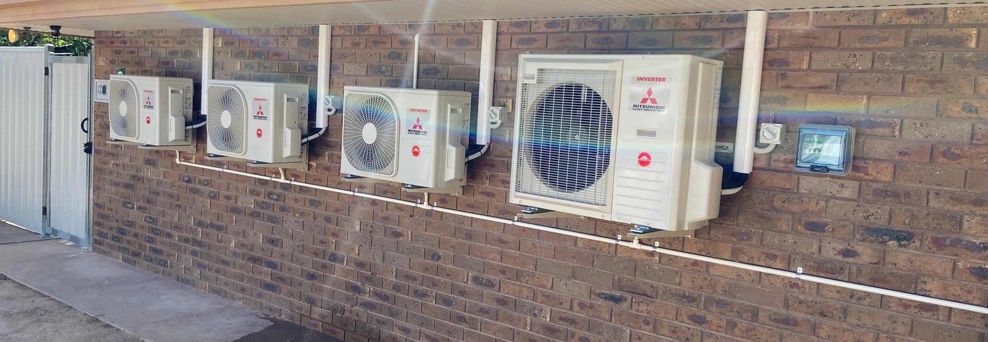 multiple split system air conditioner outdoor units mounted on wall brackets with dedicated sub boar