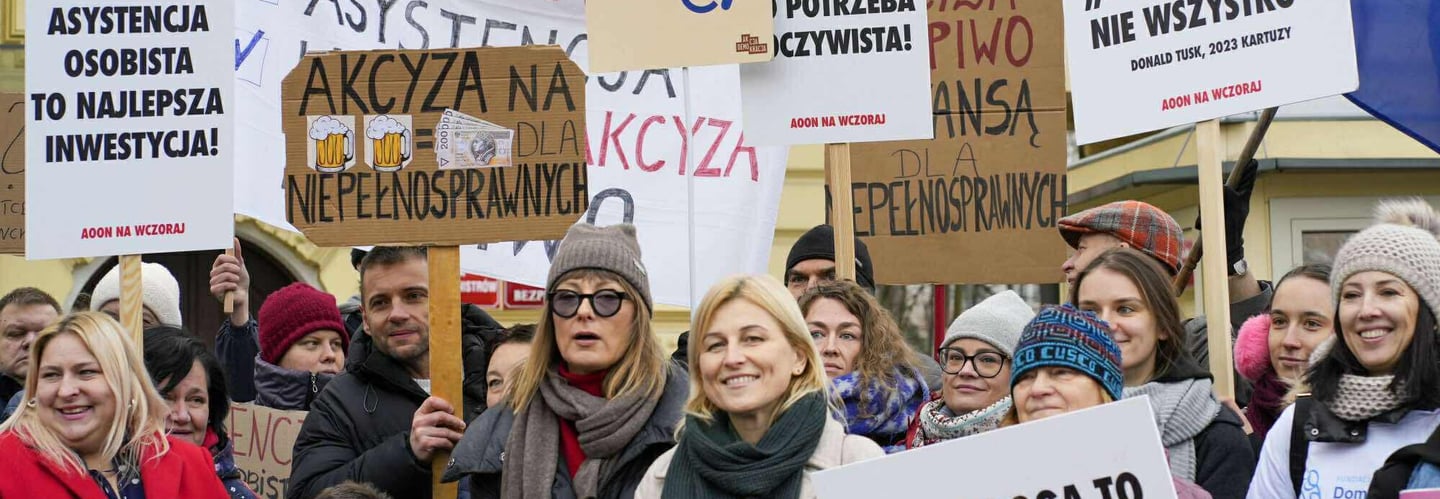 Tłum osób z transparentami. Zdjęcie z Protestu o Ustawę o asystencję osobistą przed KPRM.