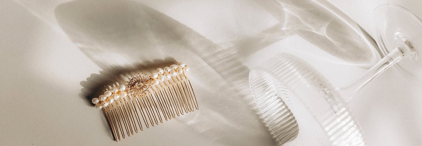 A barrette placed next to a glass of champagne.