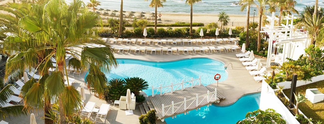 a pool with a view of the ocean and a couple of people