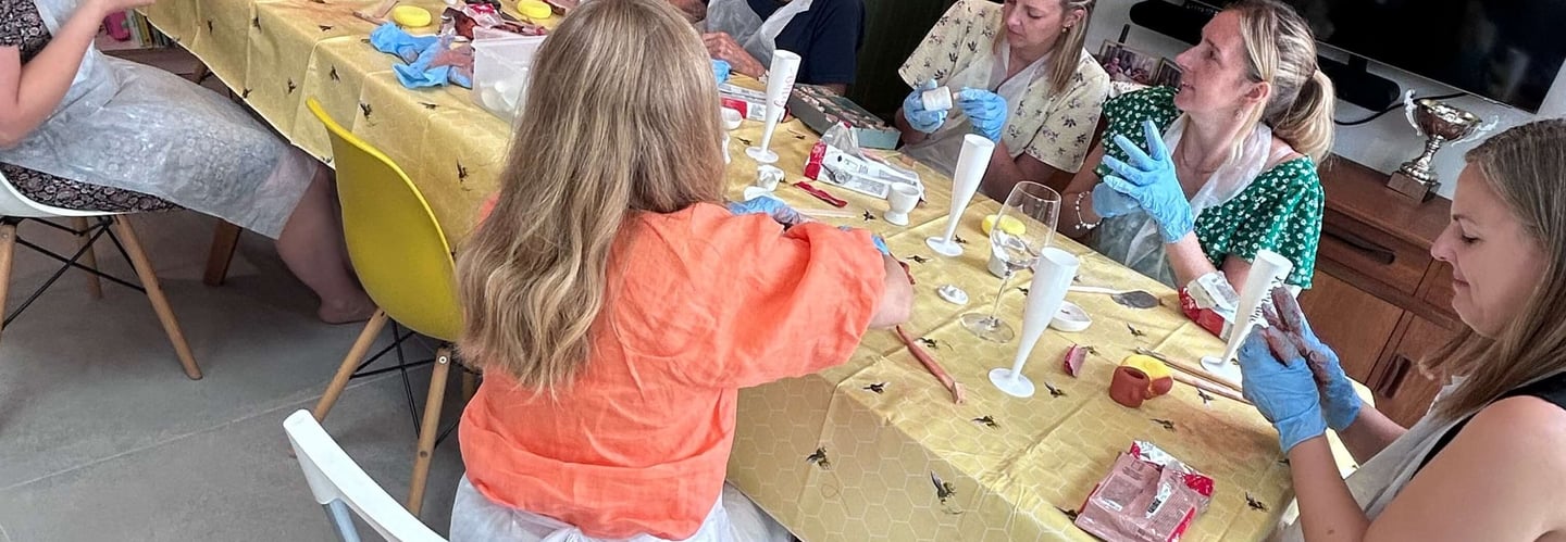a group of women at their hen party making clay boob pots