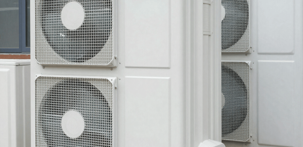 Technician in black uniform with electric gold accents repairing a high-end Sub-Zero refrigerator in a sleek modern kitchen.