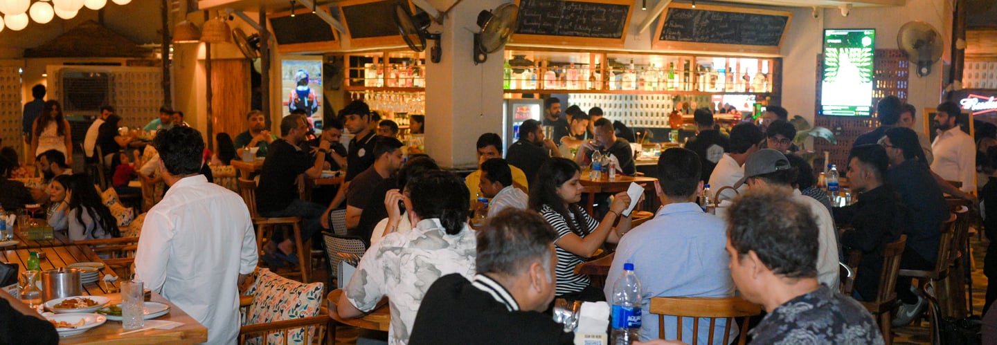 Guests enjoying cocktails, food, and live music at Filament Cocktail Bar in Pune.