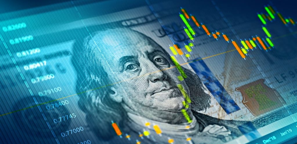 Stock market trading chart overlaid on a hundred dollar bill representing forex and financial investments.