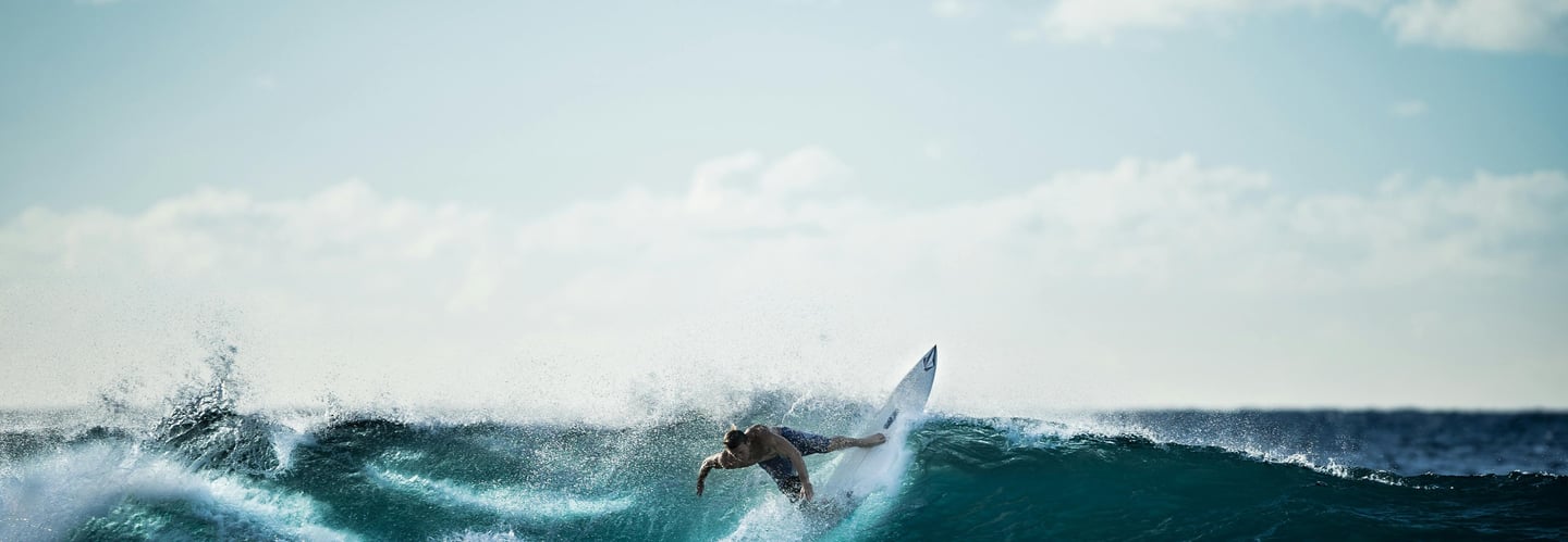 a person surfing on a big wave in the ocean