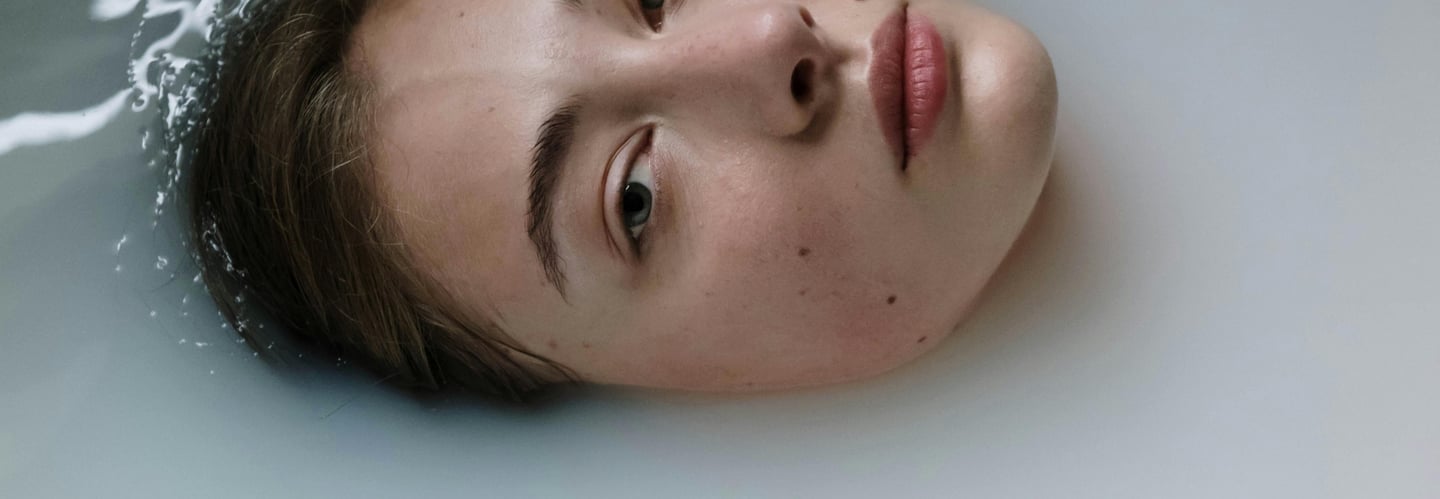 a woman in a bathtub, submerged with face showing