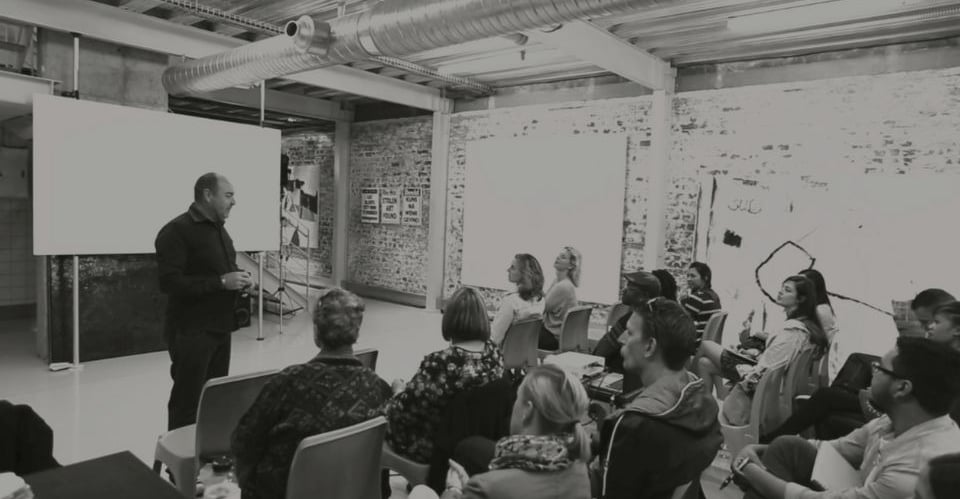 Martin Osner teaching a group of students in a workshop at the Photography School and Art Academy.