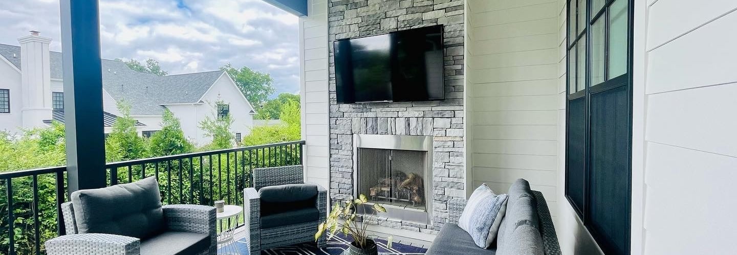 Outdoor tv mounted over stone wall. 