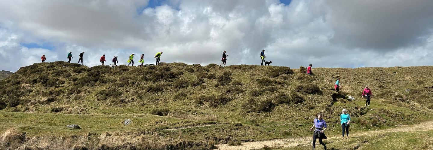 A group of runners running along a skyline