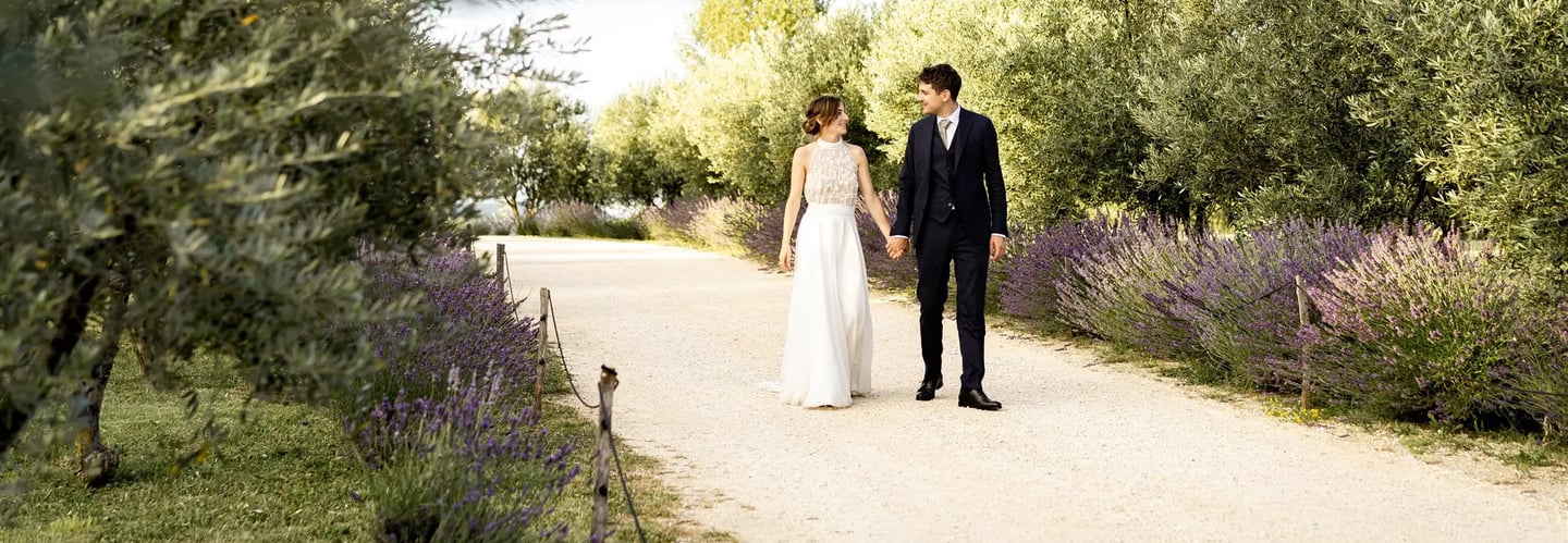 Bride and groom walking in lavender field — editorial fine art wedding photographer South of France