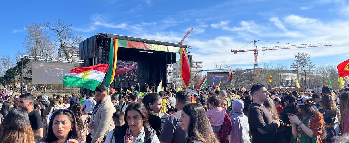 a crowd of people standing around a stage