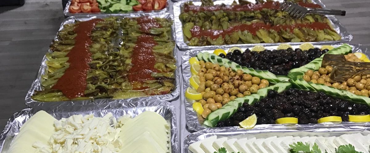 a buffet table with lots of food and people