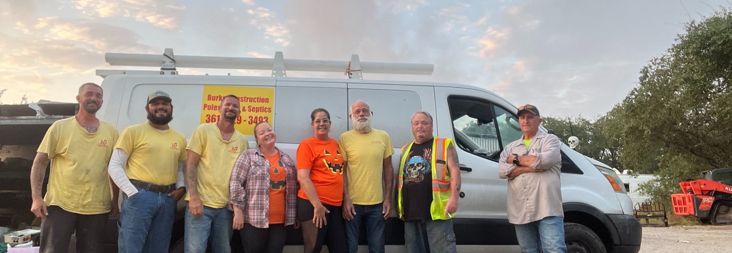 the Burke Construction crew standing in front of a van