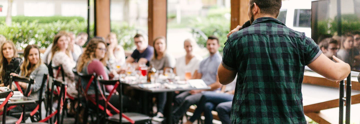 Facilitator giving a speech before dinner after a full day of team-building and leadership activity
