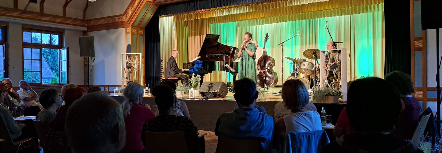 a group of people sitting at a table with a piano
