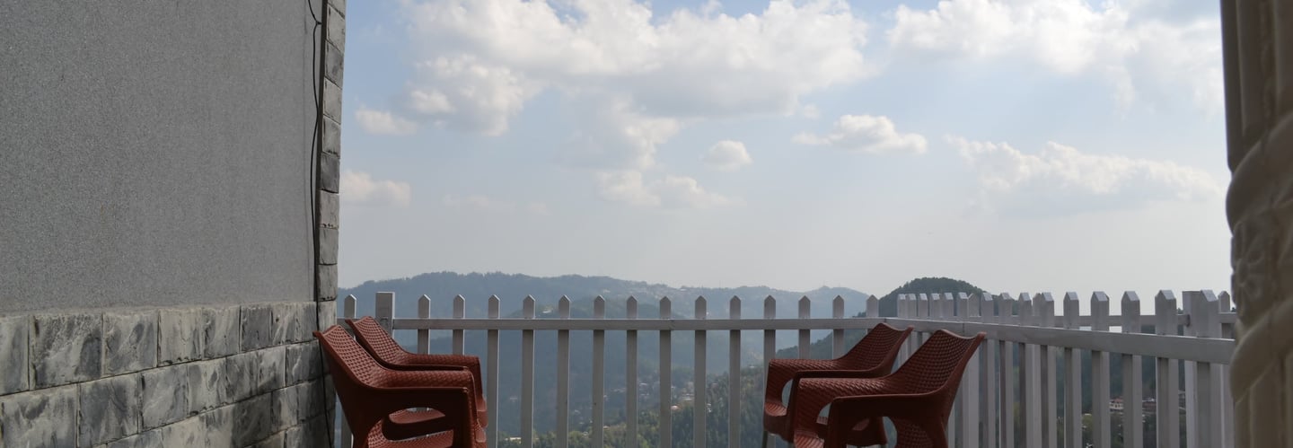 Balcony view from Sunset Heights, offering top-rated apartments for rent in Murree