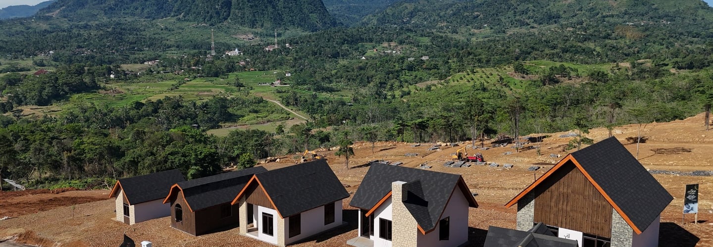 a group of houses with a mountain in the background