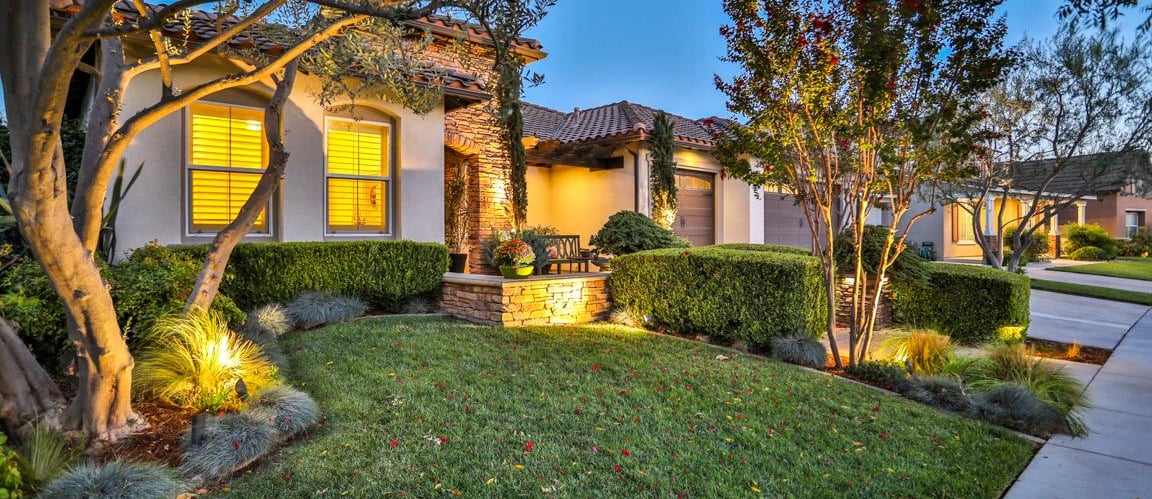 Front image of home at night all lit up