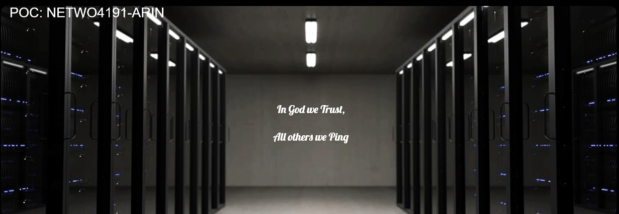 server racks in room with poster stating: In God We Trust, All Others We Ping