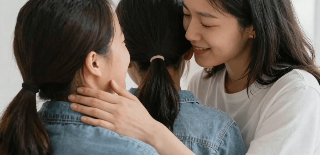 A warm, friendly caregiver sharing a joyful moment with a smiling individual during a community outing in Watchung, NJ.