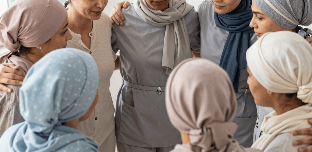 A warm group hug among children and adults illustrating support and courage.