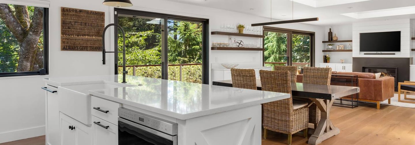 a kitchen with a large window and a table with chairs