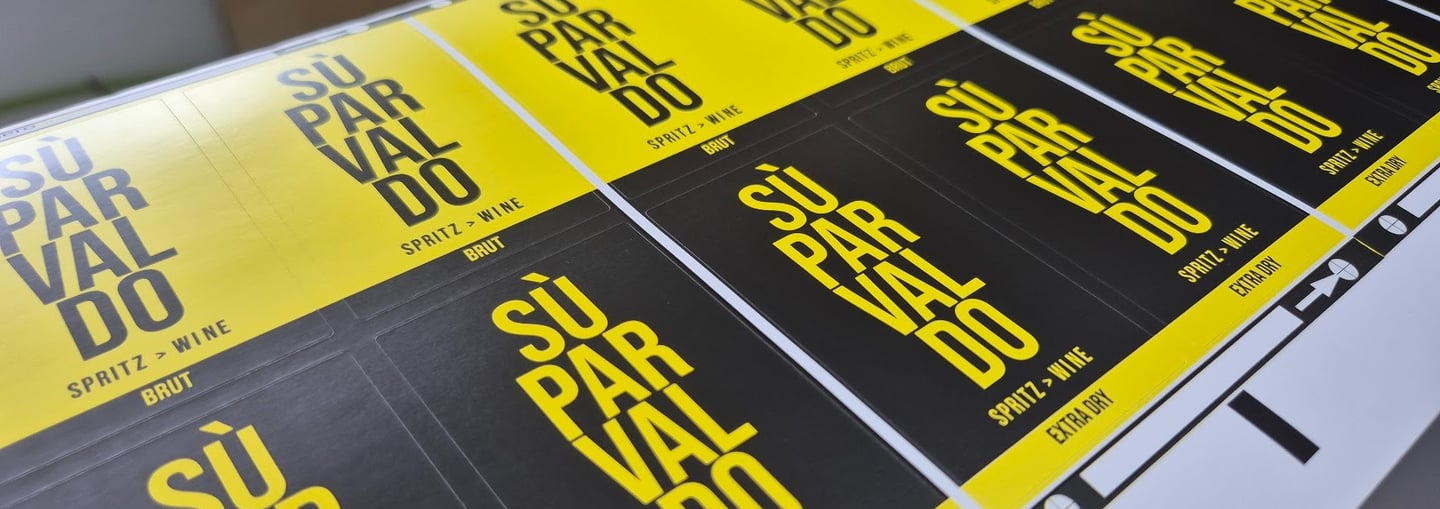 Custom printed Su Par Valdo spritz wine labels in yellow and black on a sheet.