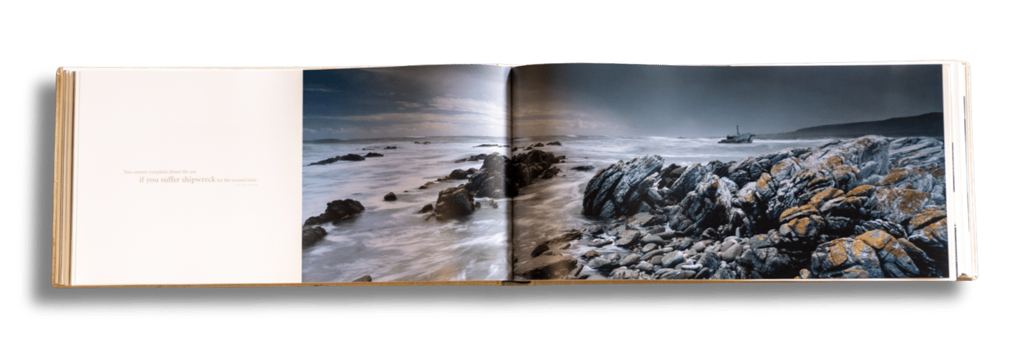 Panoramic coastal landscape spread from the Moments of Grace coffee table book by Koos van der Lende.