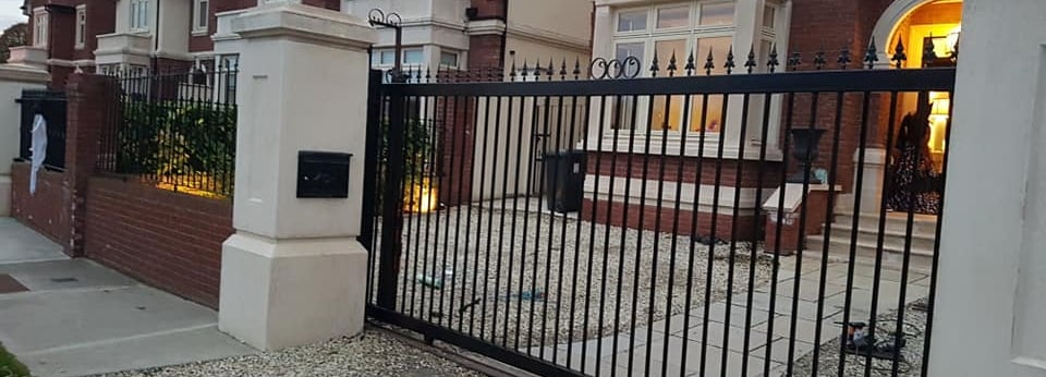 a gated in front of a house with a black gate