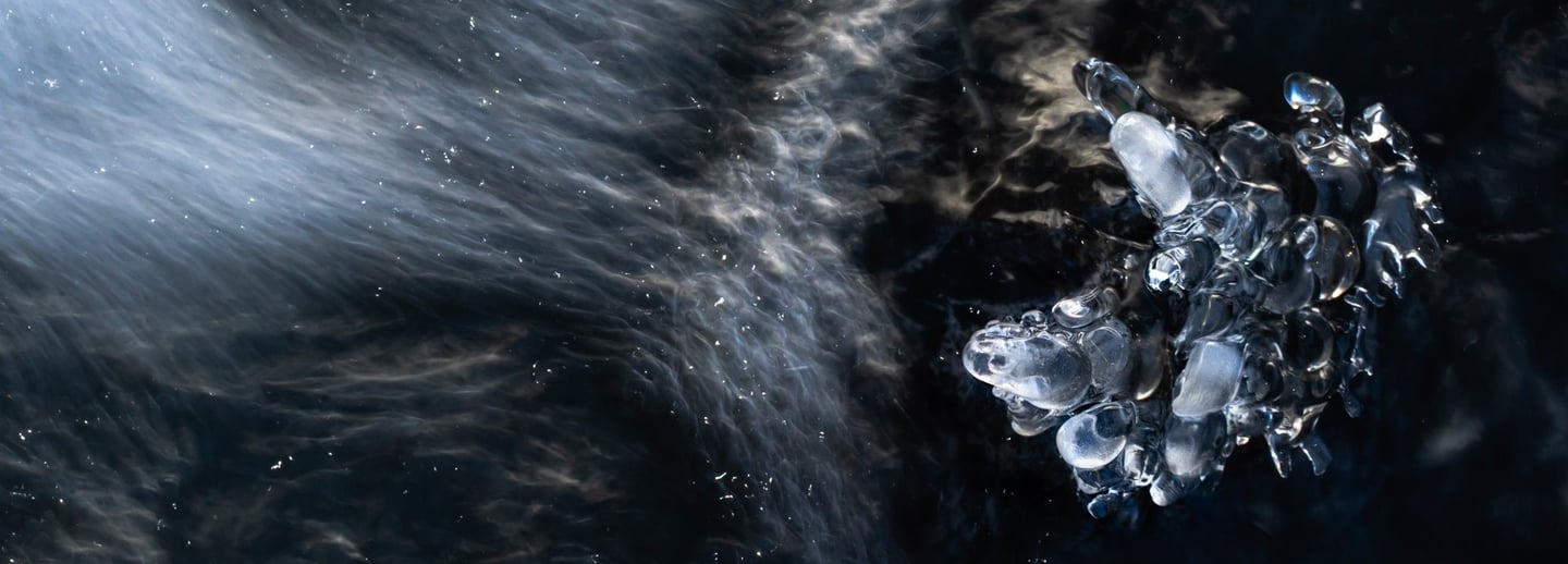a piece of ice with water and ice crystals