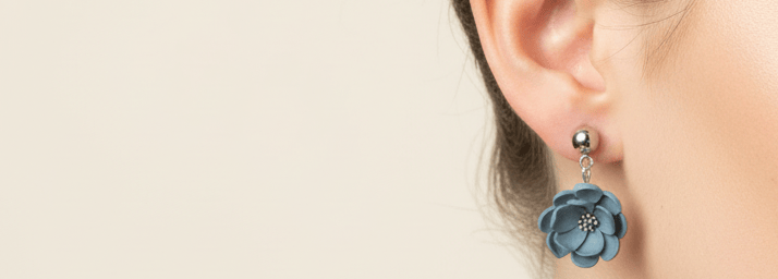 a woman with a blue flower earrings
