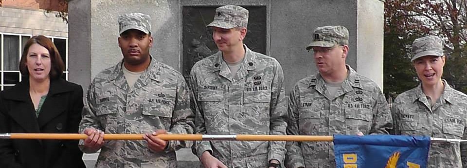 The Ohio University AFROTC cadre staff holding the unit flag, being silly. Cynthia  is on far right.