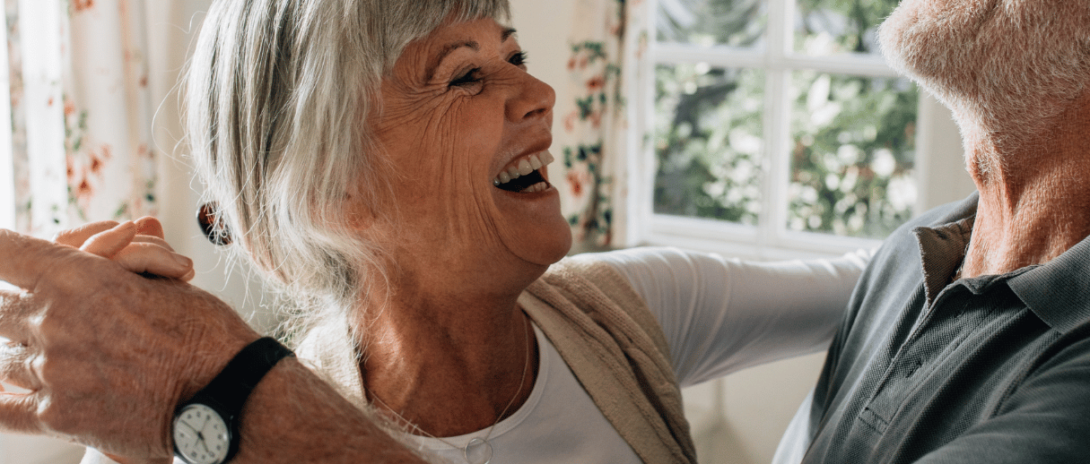 Older couple smiling and dancing together