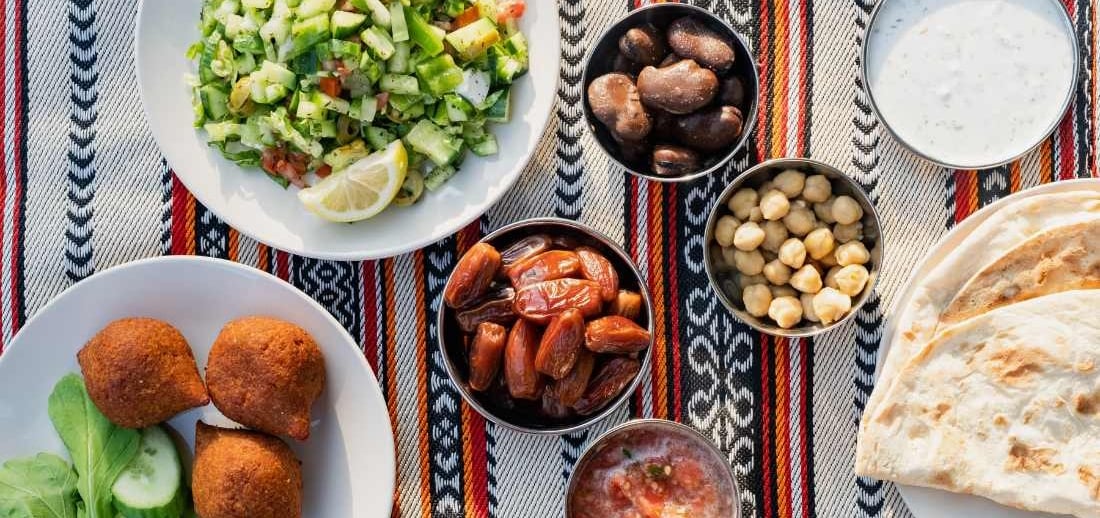 a table with plates of food and a bowl of food