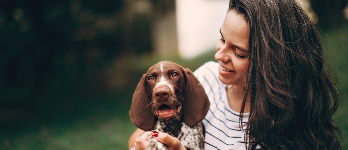 A woman holding a dog