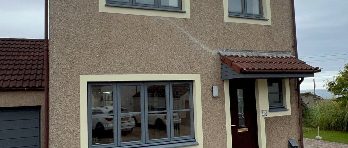 a house with a driveway and garage door