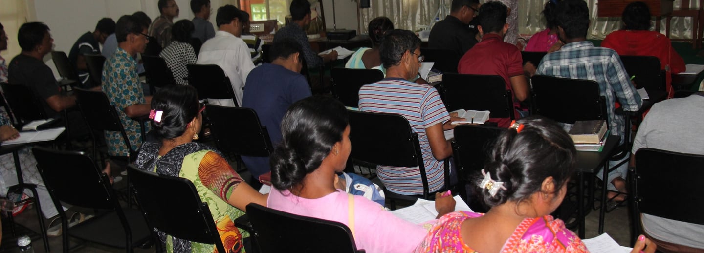 a group of people sitting in chairs in a room