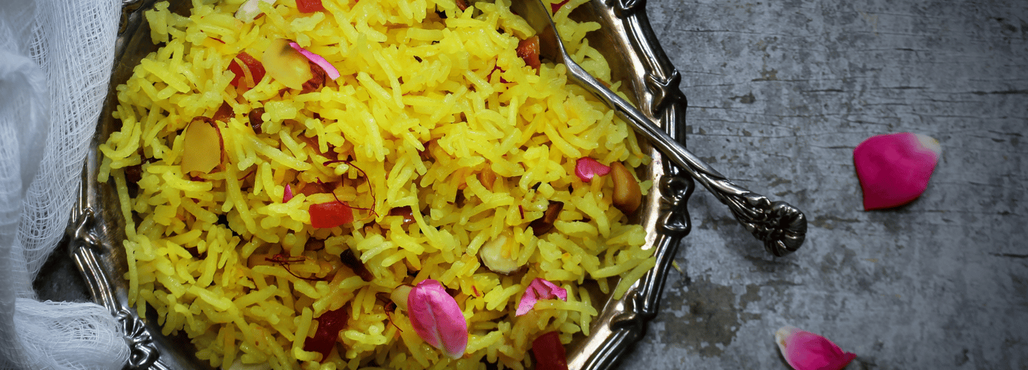 a bowl of saffron rice with a spoon