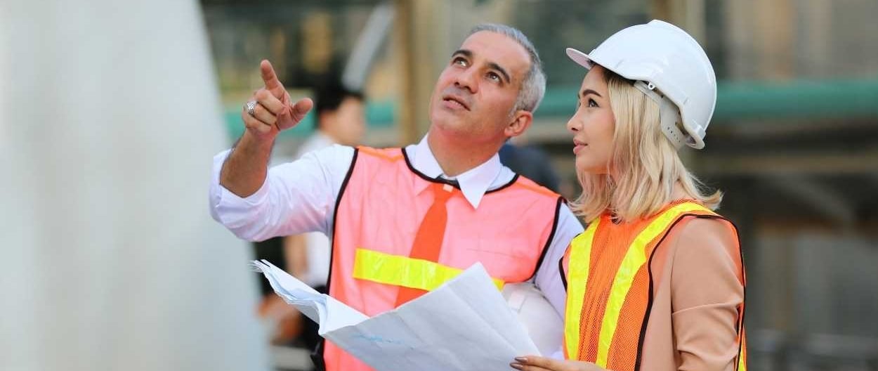 a man and woman in safety vests and safety vests