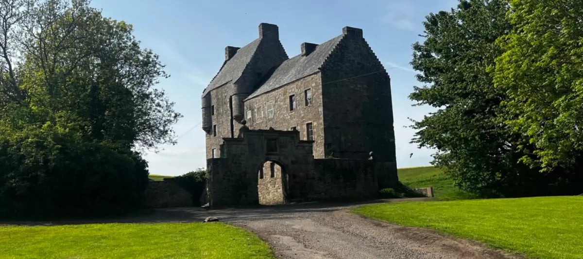 a large stone building with a large stone archway to the front