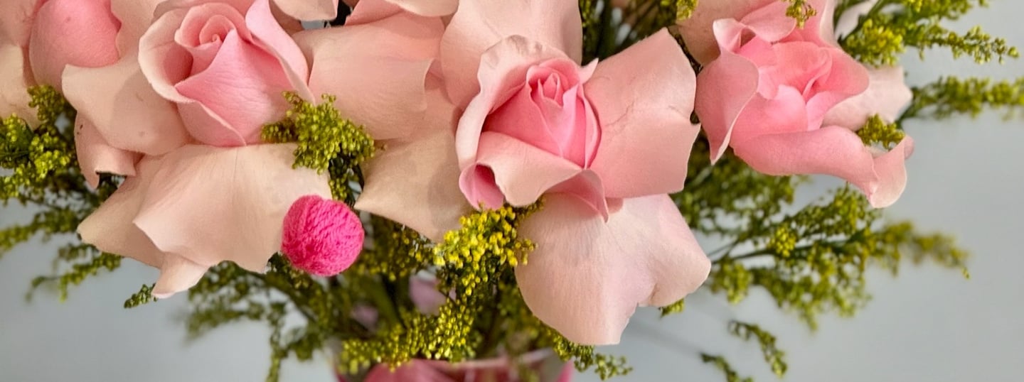 a vase with pink roses in a vase