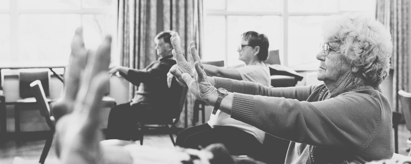 Chair Yoga class hands raised and wrists bending