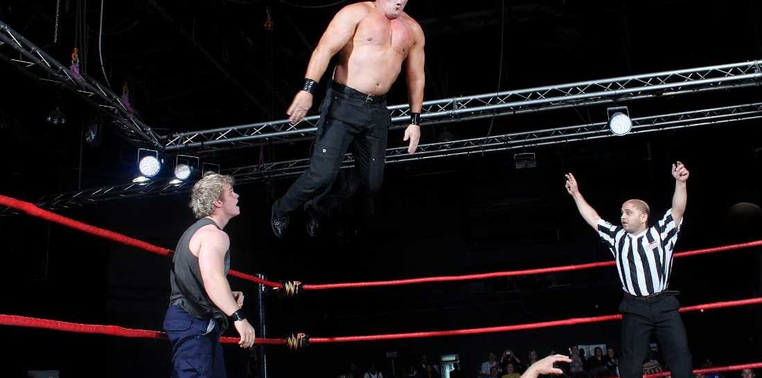 a man in a referee's uniform is jumping in the air