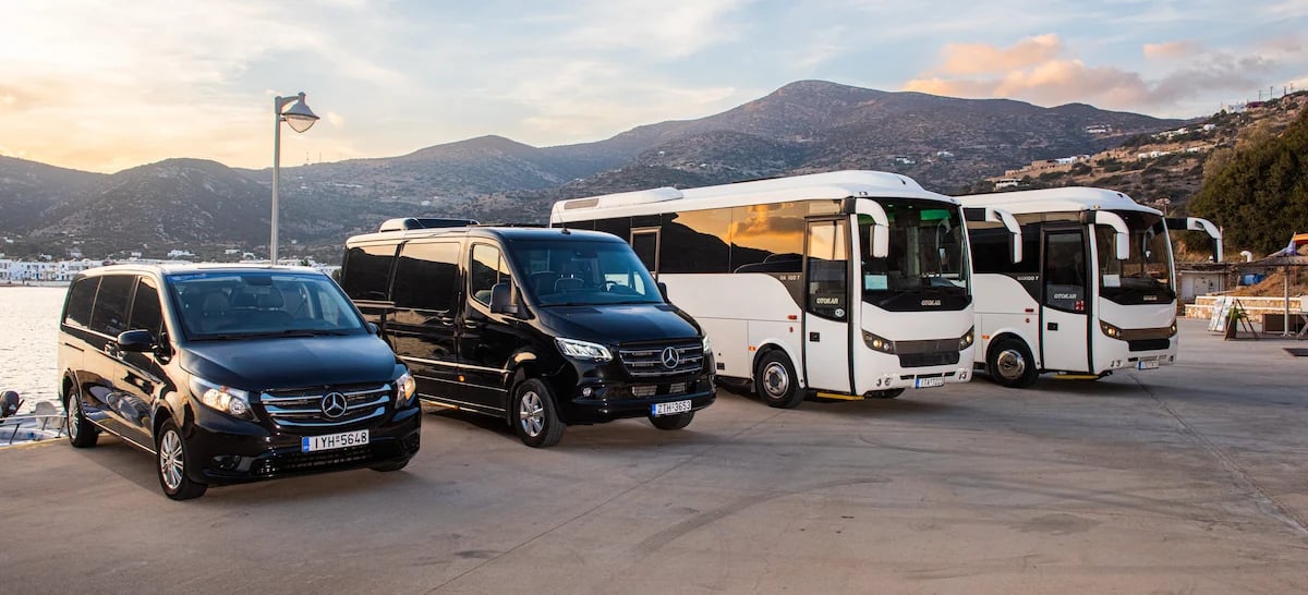 Fleet of luxury Mercedes vans and white tourist buses for group transfers and tours in Sifnos.