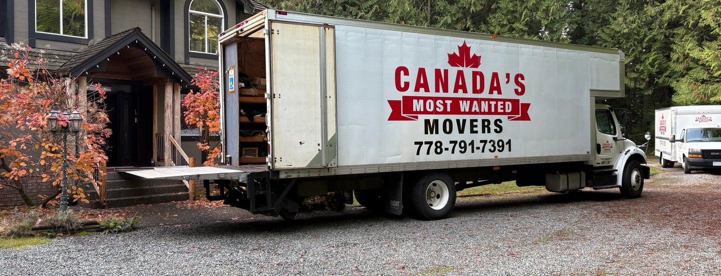 Canada’s Most Wanted Movers truck parked at a forest-side home in the Lower Mainland during a residential move.
