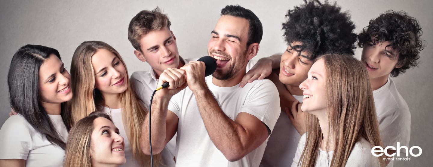 Group enjoying a karaoke system rental in Dubai with wireless mics.
